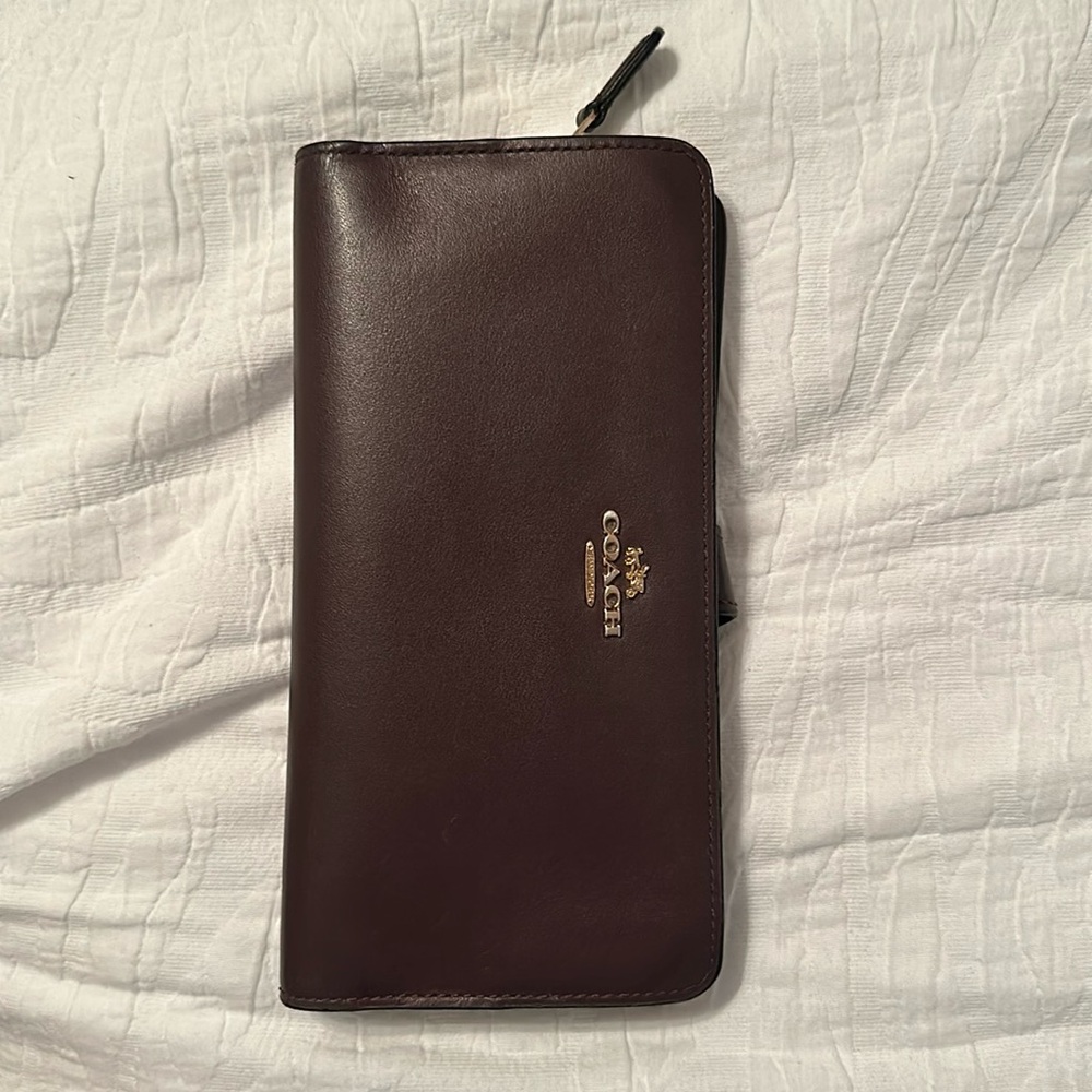 Coach burgandy smooth leather wallet. Good condition outside. Wear on inside